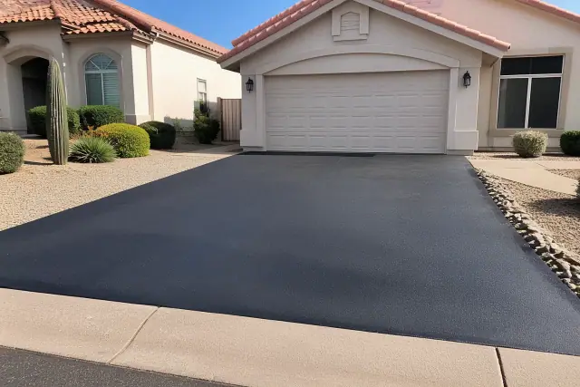 Newly installed asphalt driveway with sealcoating at a suburban home in Glendale, AZ.