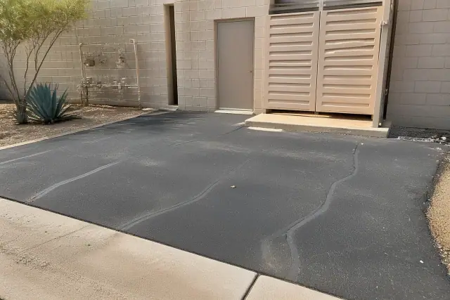 Freshly repaired asphalt cracks at a commercial service entry in Chandler, AZ.