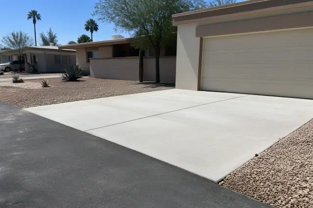 New concrete driveway apron with broom finish and asphalt transition at a ranch house in Tempe, AZ.