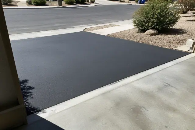 Asphalt patch between a residential garage and a new driveway in Queen Creek, AZ.