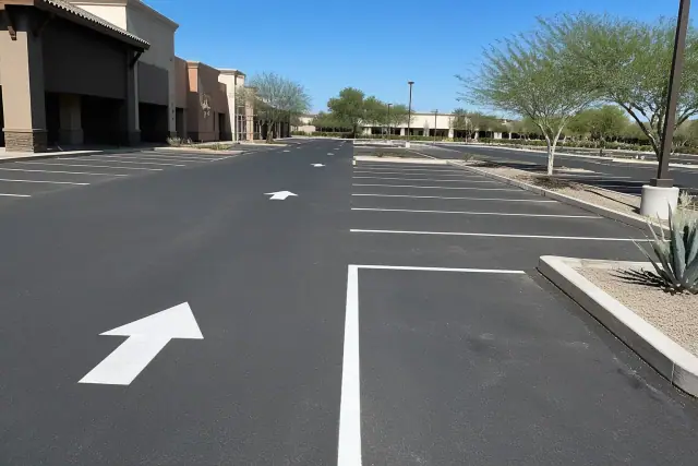 Freshly painted parking stall lines and directional arrows in a retail center parking lot in Tempe, AZ.