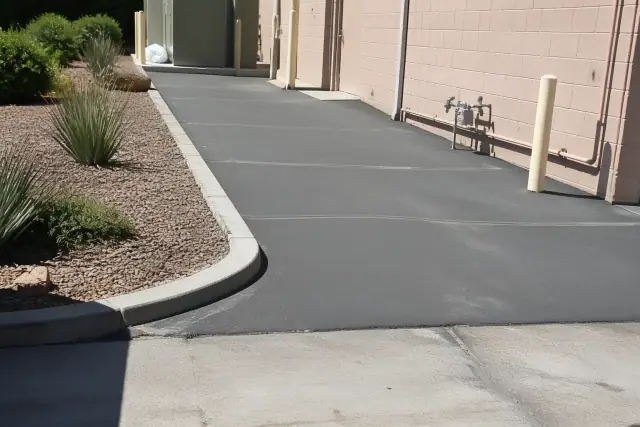 Repaired pavement at a commercial building rear utility entrance in Tempe, AZ.