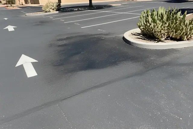 Oil spot pre-treatment on an asphalt parking lot in Tempe, AZ.