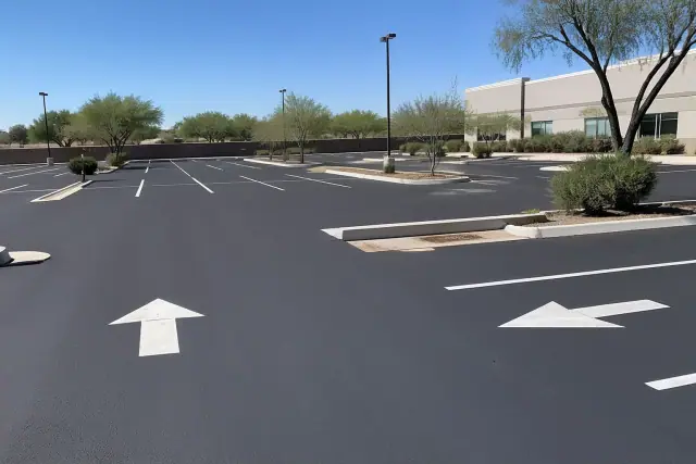 Freshly painted parking stall lines and directional arrows in a parking lot in Tempe, AZ.