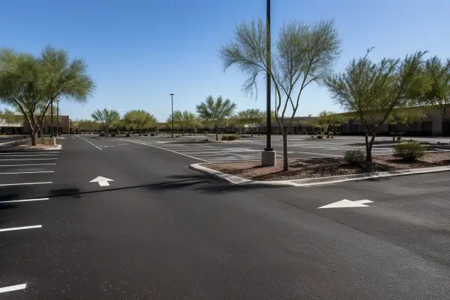 Freshly milled asphalt parking lot with new striping and xeriscaping in Tempe, AZ.