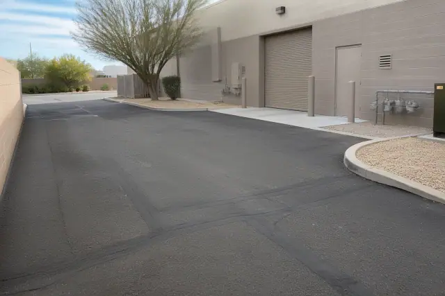 Asphalt crack filling and patching at a commercial building entrance in Tempe, AZ.