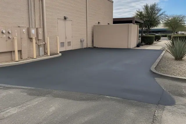 Freshly resurfaced asphalt with crack filling at a commercial property in Tempe, AZ.