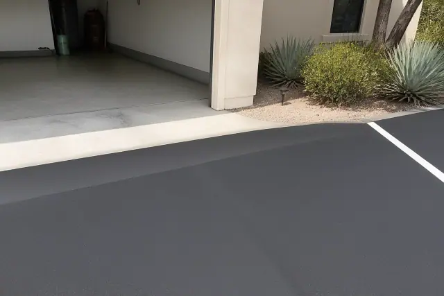 Newly sealcoated asphalt driveway with line striping at a residential home in Tempe, AZ.