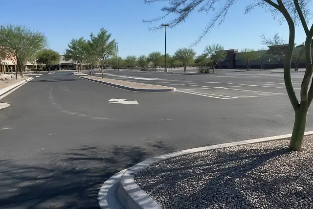 Freshly painted parking lot stripes and directional arrows at a retail center in Tempe, AZ.