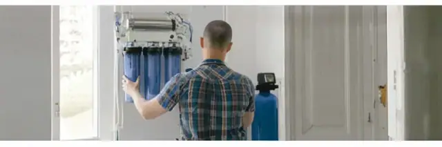 Technician installing a water filtration system
