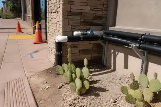 Professional plumbing connections and insulation at a retail water filtration site in Tempe, AZ.