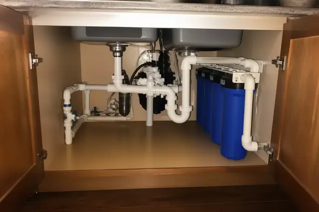 Commercial sediment filtration system installed under a residential kitchen sink in Tempe, AZ.