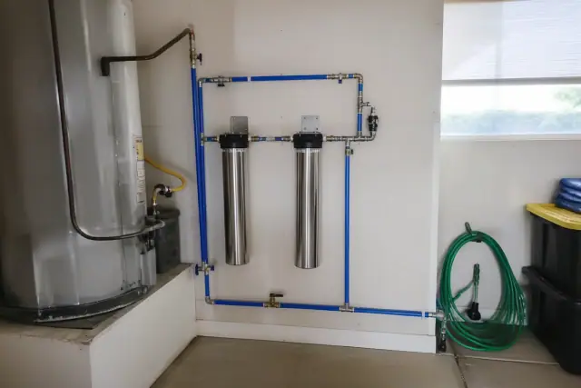 Commercial water filtration system installed in a garage next to a water heater in Scottsdale, AZ.