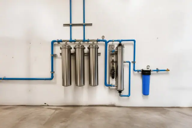 Stainless steel commercial water filtration system installed in a business back room in Surprise, AZ.