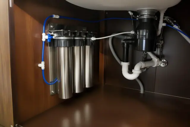 Commercial water filtration system installed under a residential kitchen sink in Tempe, AZ.