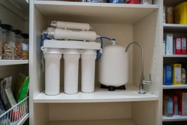 Reverse osmosis water filtration system installed on a pantry shelf in a home in Tempe, AZ.