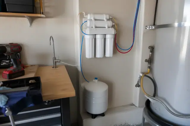 Reverse osmosis water filtration system installed on a garage wall in Tempe, AZ.
