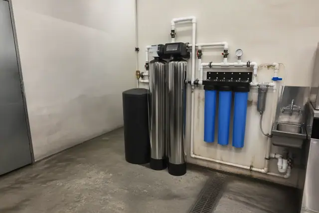 Water softener and filtration system installed in a restaurant utility room in Glendale, AZ.