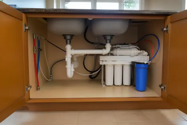 Reverse osmosis water filtration system installed under a kitchen sink cabinet in Tempe, AZ.