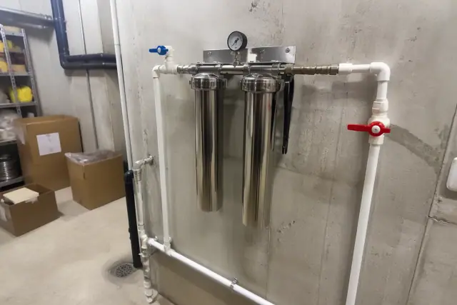 Newly serviced commercial water filtration system with stainless steel pipes in a restaurant in Goodyear, AZ.