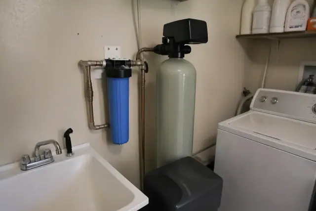 Water softener system installed in a laundry room in Tempe, AZ.