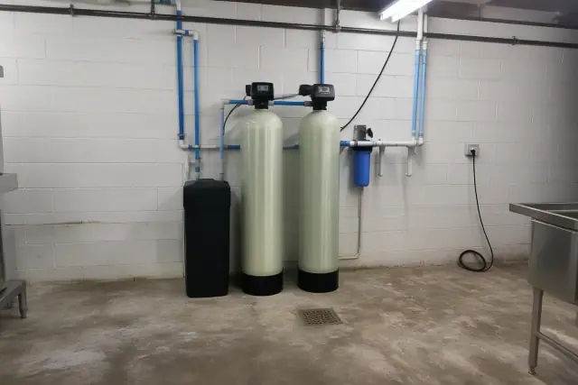 Water softener and filtration system installation in a utility room in Mesa, AZ.