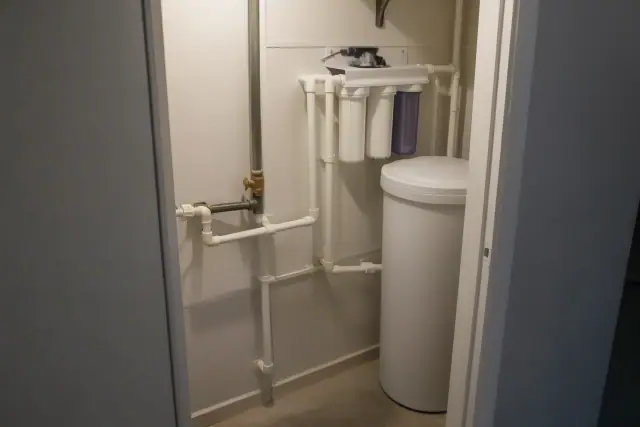 Whole-house water filtration system installed in a mechanical closet in Tempe, AZ.