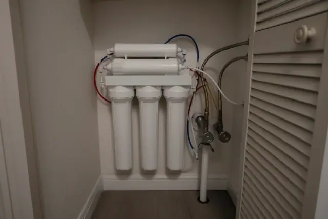 Multi-stage reverse osmosis water filtration system installed in an apartment mechanical closet in Tempe, AZ.