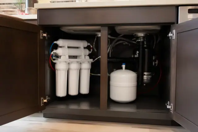 Multi-stage water filtration system installed under a kitchen sink in Tempe, AZ.