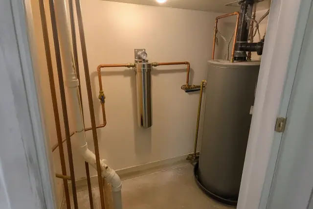 PFAS water filtration system with copper piping installed in a residential mechanical closet in Tempe, AZ.