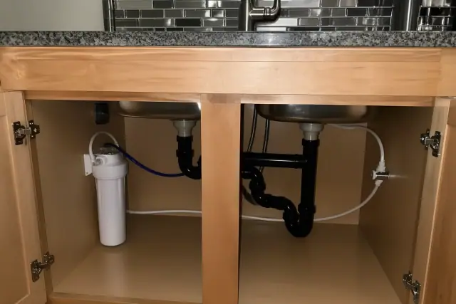 Under-sink water filtration system installed in a kitchen cabinet in Mesa, AZ.