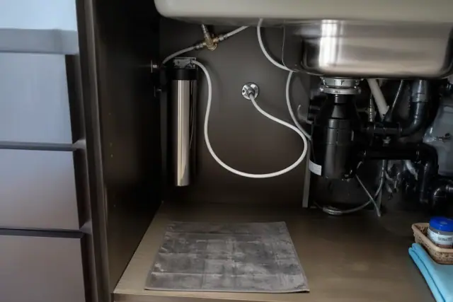 Under-sink water filtration system installed in a kitchen cabinet in Tempe, AZ.