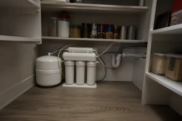 Reverse osmosis water filtration system installed on a shelf in an Avondale, AZ pantry.
