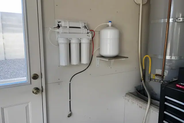 Reverse osmosis water filtration system installed on a residential garage wall in Surprise, AZ.
