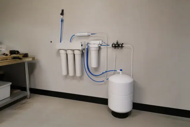 Reverse osmosis water filtration system installed in a utility room in Gilbert, AZ.