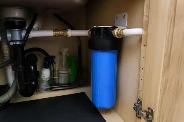 New sediment water filter installed under a kitchen sink in a Tempe, AZ home.