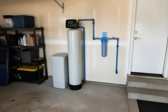 Water softener and sediment filter system installed on a garage wall in Peoria, AZ.