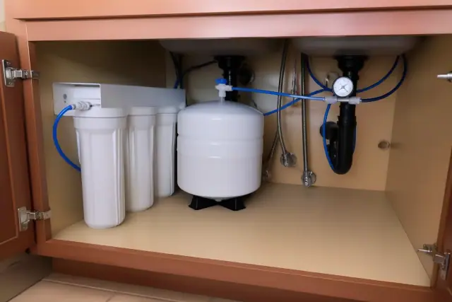 Under-sink water filtration system installed in a residential pantry in Tempe, AZ.