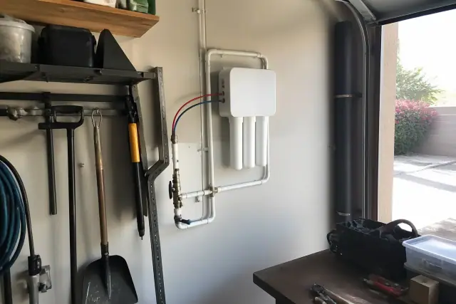 Tankless reverse osmosis water filtration system installed on a garage wall in Tempe, AZ.