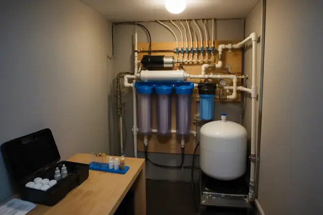 Water purification system with sediment filters and testing equipment in a utility closet in Tempe, AZ.