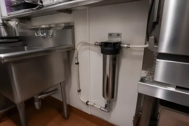 New under-sink carbon water filter installation in a Tempe, AZ restaurant kitchen.