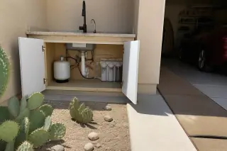 Under sink water filtration system with plumbing installed in a Tempe, AZ home.