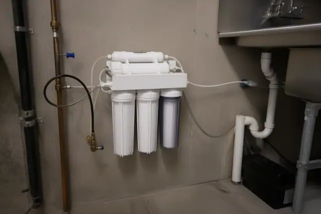 Reverse osmosis water filtration system installed under a sink in a commercial room in Tempe, AZ.
