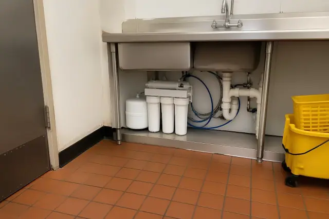 Reverse osmosis water filtration system installed under a commercial sink in Tempe, AZ.