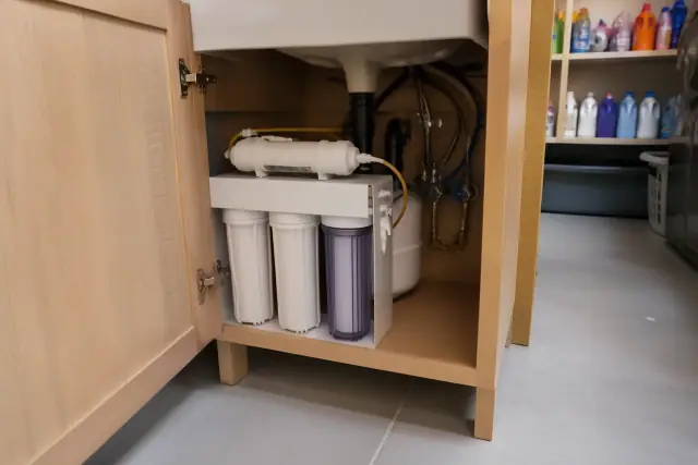 Reverse osmosis water filter system installed under a laundry room sink in a home in Tempe, AZ.