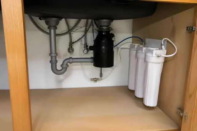 Water filtration system installed under a kitchen cabinet in Tempe, AZ.
