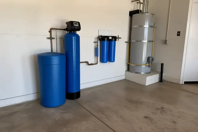 Water softener and under-sink filtration system installed next to a water heater in a Phoenix, AZ garage.