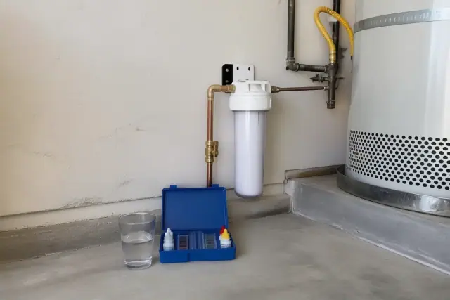 Water filtration system installed next to a water heater in a Tempe, AZ garage.