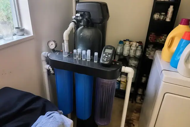 Water testing equipment and sample vials on a filtration system in a laundry room in Tempe, AZ.