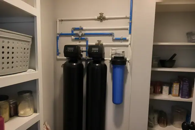 Water softener and filtration system with PEX piping installed in a Tempe, AZ residential pantry.